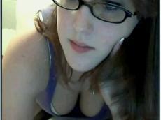 Busty girl in glasses plays with clit
